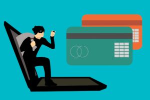 Illustration d'un ordinateur portable ouvert au travers duquel un voleur s'infiltre, équipé d'une lampe torche et se déplaçant en direction de deux cartes bancaires.